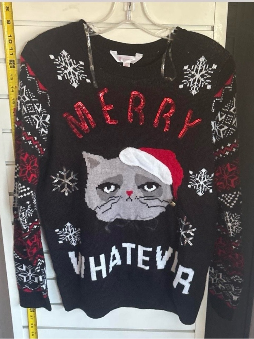 Black Christmas sweater with gray cat in red Santa hat. Fits more like a large.